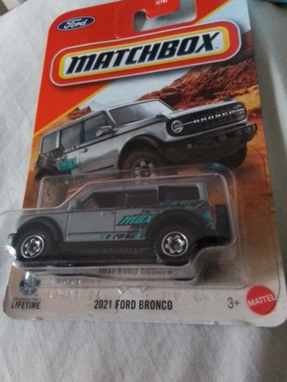 Matchbox 2021 Ford Bronco Toy Car in Gray with Teal Graphics